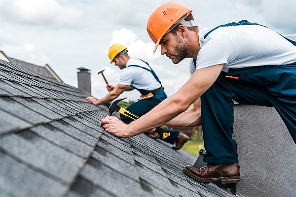 Roofing contractors replacing a roof