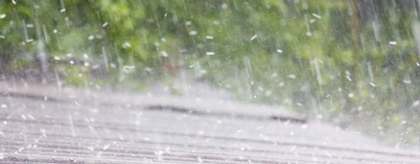 Roof Replacement - Can You Remain in Your Home While Redoing the Roof? hail falling on roof roof replacement concept